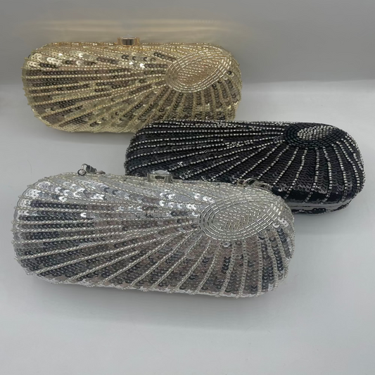 Three beaded clutch bags in gold, silver, and black on a white background