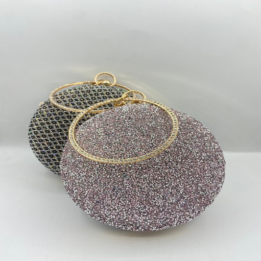 Sparkly circular earrings with gold accents on a light gray background