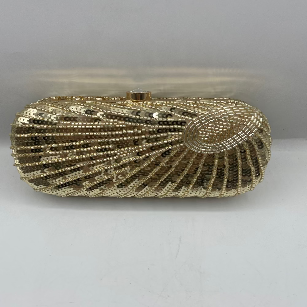 Gold beaded clutch bag on a white background