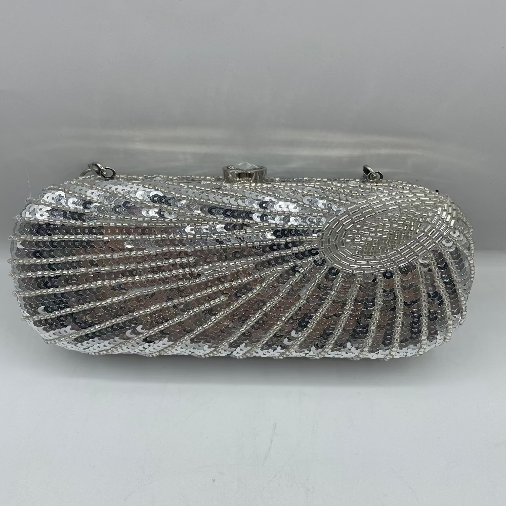 Silver beaded clutch bag on a light gray background