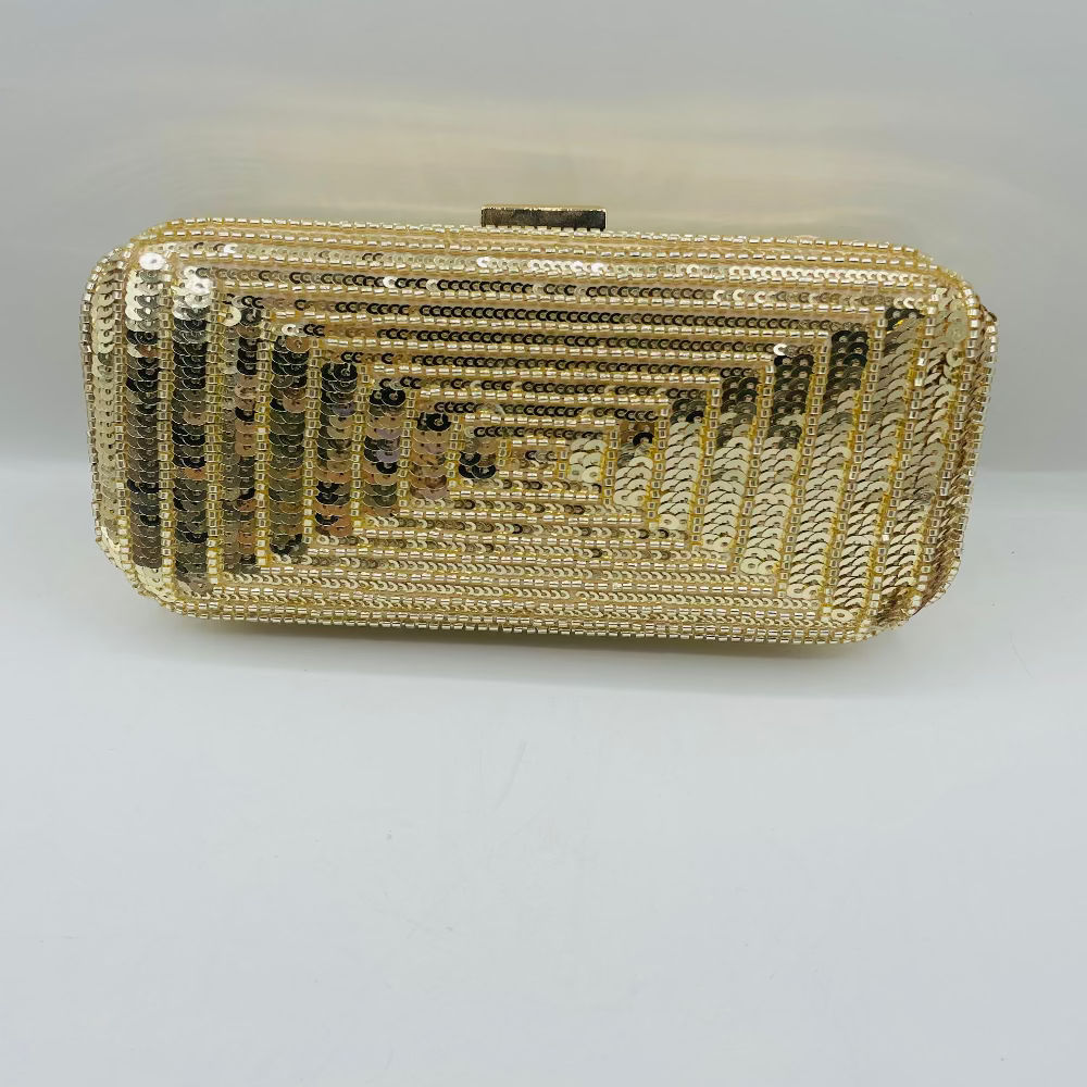Gold beaded clutch bag on a light gray background