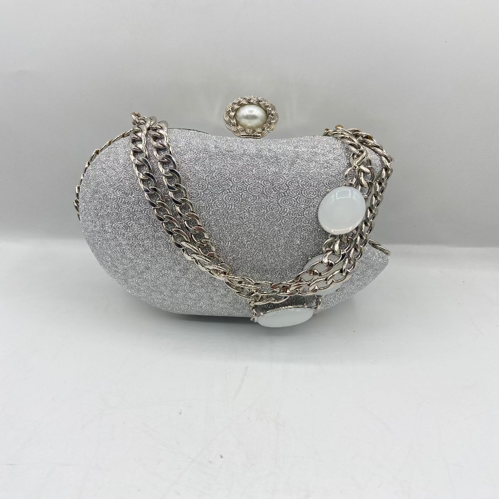 Silver bracelet with chain and round elements on a gray textured surface
