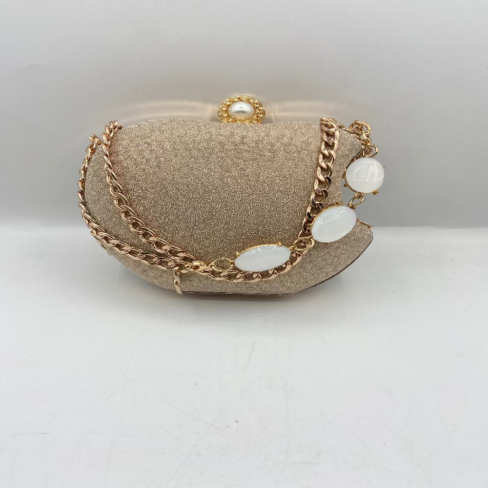 Gold chain necklace with white stones on a white background